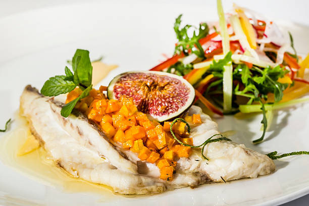 istock baked cod with a salad of arugula and figs 487544282
