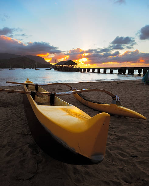 Kayak Sunset Hanalei Bay with Kayak in the foreground during sunset, Kauai, Hawaii hanalei bay stock pictures, royalty-free photos & images