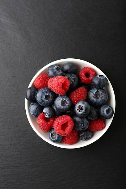 istock Raspberries and blueberries in a bowl 487544700