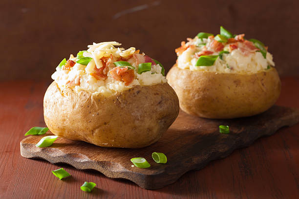 istock baked potato in jacket with bacon and cheese 487548990