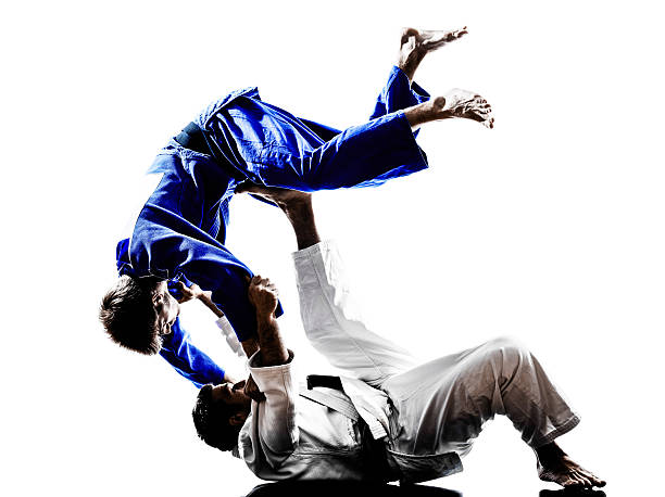 judokas fighters fighting men silhouettes two judokas fighters fighting men in silhouettes on white background judo photos stock pictures, royalty-free photos & images