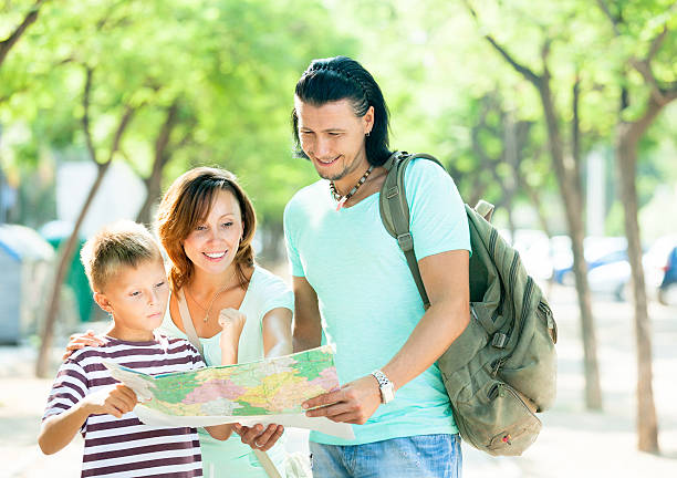 istock family of three searching way at paper map 487551259