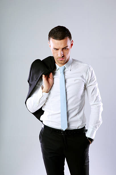 istock business man holding jacket on shoulder 487551591