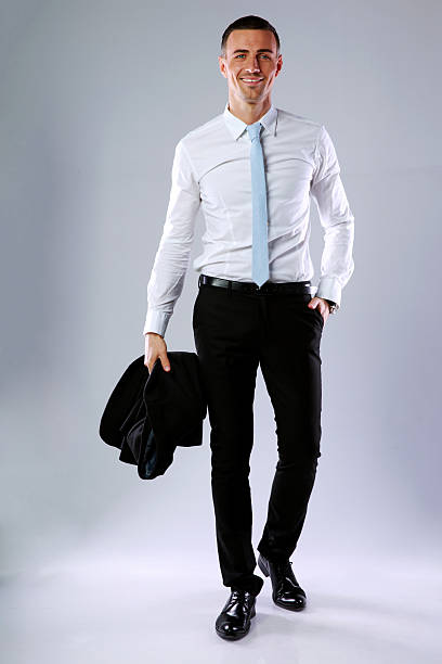 istock happy business man holding jacket 487552083