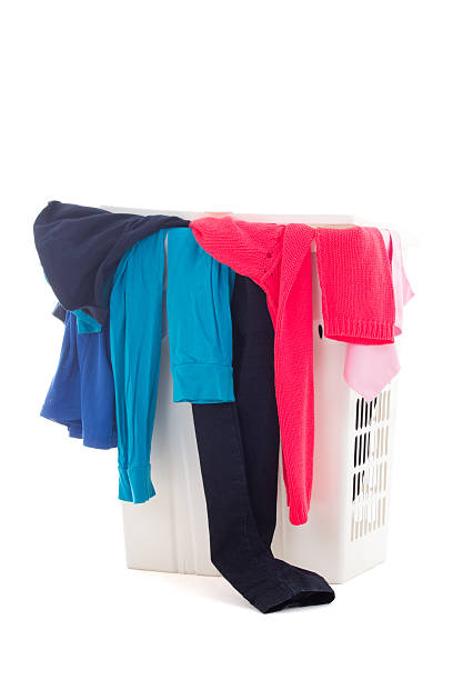 istock dirty clothes in a laundry basket on white background 487552207