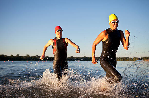 istock Triathlon Participants Running in The Water. 487552829