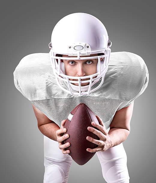 istock Football Player on white uniform on gray background 487553308