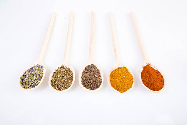 Dried spices on spoons stock photo