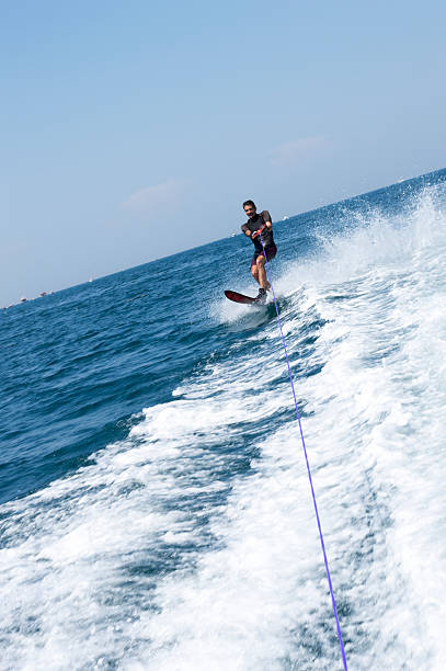 istock Attractive young man is skiing on water 487554080