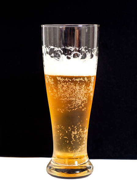 Glass of beer on black background