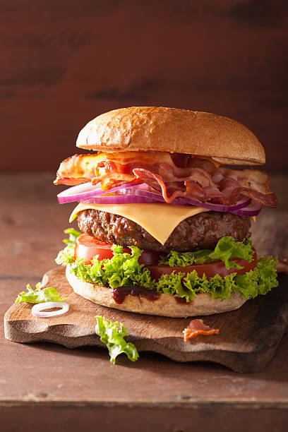 istock bacon cheese burger with beef patty tomato onion 487554992