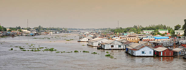 istock Floating village and transport boat on river 487555262