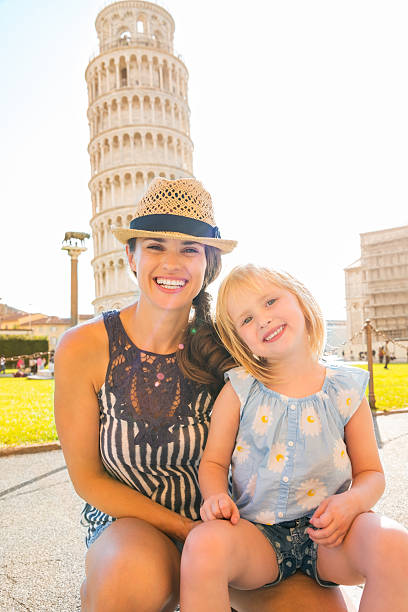 istock Mother kneeling with daughter sitting on her lap in Pisa 487555456