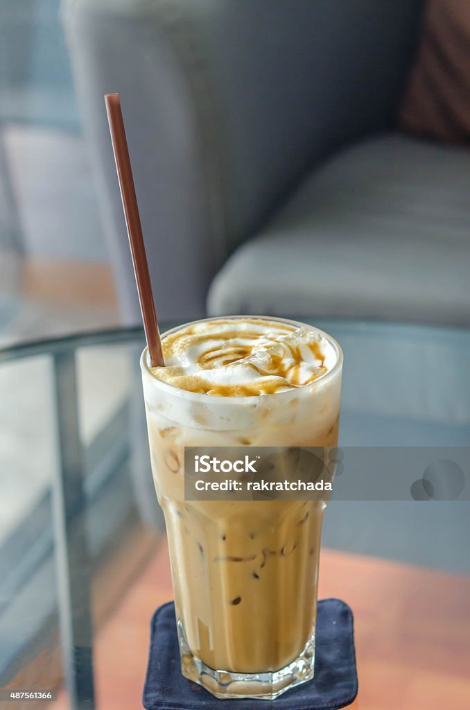 caramel stained iced caramel macchiato , coffee in glass with drinking straw Cafe Macchiato Stock Photo
