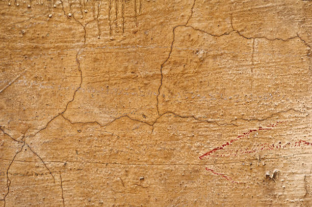 istock Texture of old wall covered with yellow stucco 487563436