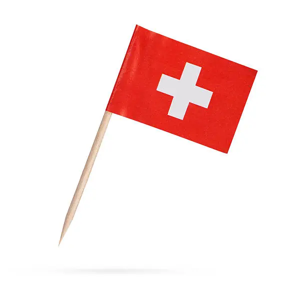 Miniature paper flag Switzerland. Swiss Flag Isolated on white background. With shadow below