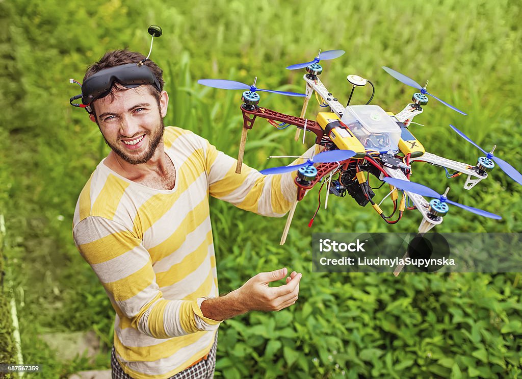 man playing with his copter in the field Fuel and Power Generation Stock Photo