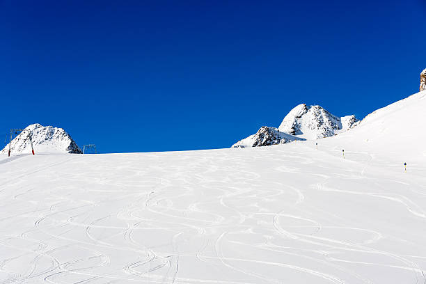Fresh ski tracks on ski slope Fresh ski tracks on ski slope with new white snow at the ski resort Soelden in the Austrian Alps. tiefenbach stock pictures, royalty-free photos & images