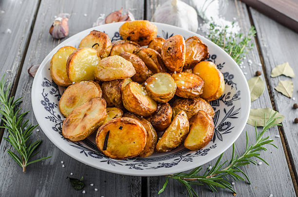 istock Baked potatoes with herbs and garlic 487569472
