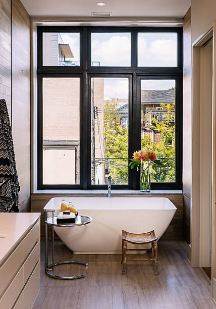 Toronto, Ontario, Canada-August 11, 2015. Modern interior of upper levels, part of newly designed and constructed Luxury Condo Apartment in Toronto, Canada. This space is converted from turn of the century Church, made in to several high end multilevel apartments. High end property is located in very downtown of the city, near one of the most desirable and colorful areas in West End  with lots of restaurants, shops and places of entertainment, in the area with mostly older houses and buildings. Interior design features color coordinated furniture and fabrics, art work on the wall and around the world souvenirs. Modern and elegant.