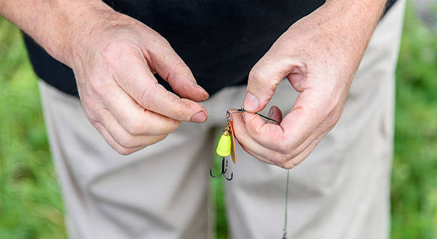 istock Fisherman hands tied hook. Closeup. Fishing 487574084