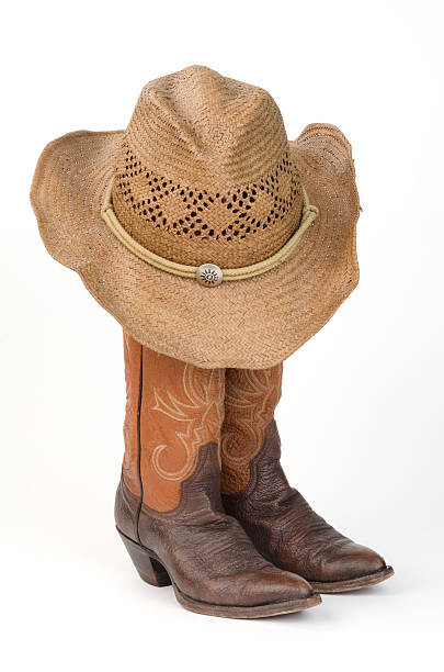 istock Ladies Cowboy Boots with Straw Hat. 487574505