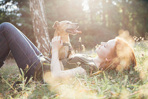 redhead jeune fille et son chien s'amuser en plein air - side of flash photos et images de collection