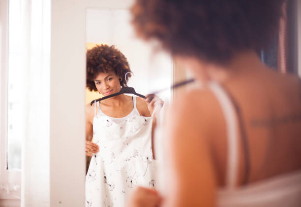 istock Young woman trying on dress 487583370