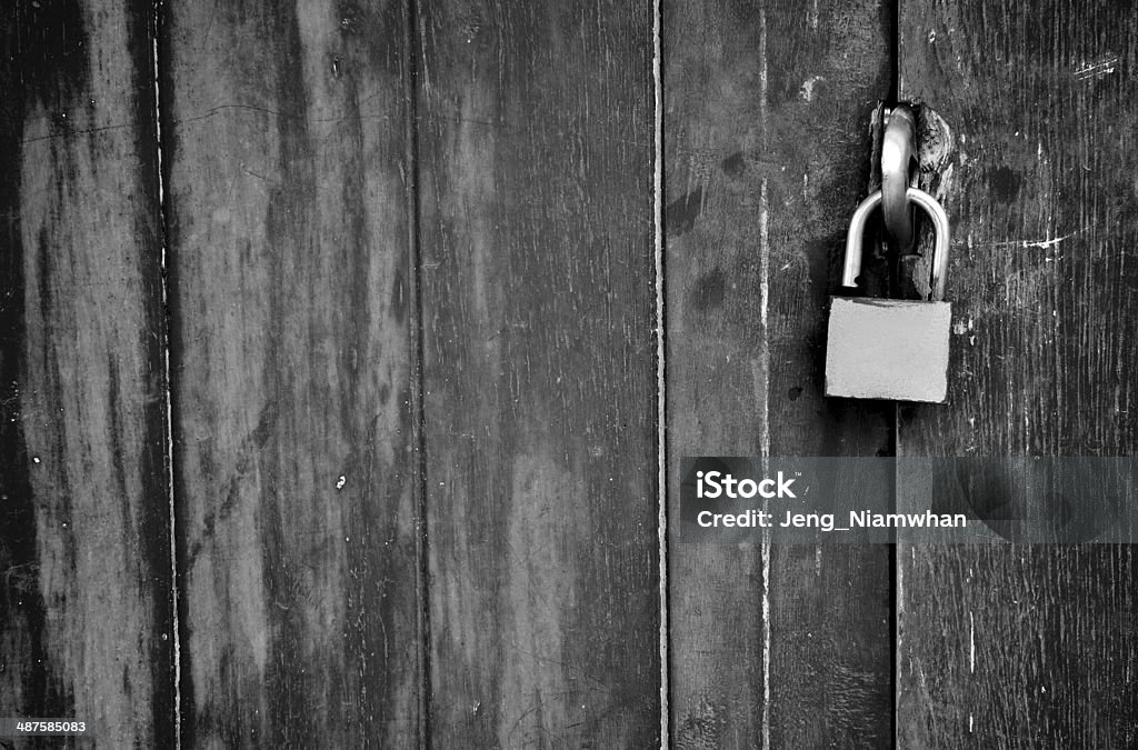 Old padlock on a wooden door Abandoned Stock Photo