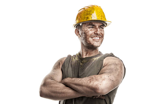 portrait of dirty worker with helmet crossed arms stock photo