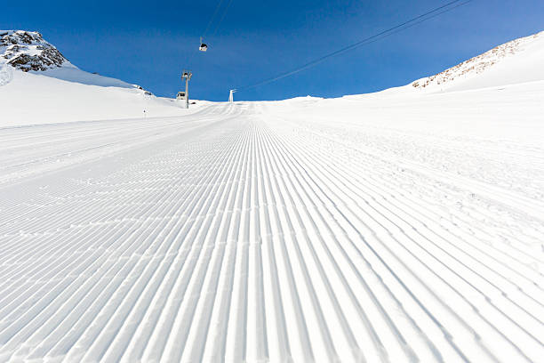 Newly groomed ski slope on a sunny day Beautifully groomed ski slope on the Tiefenbach glacier at the popular ski resort Soelden in Austria. tiefenbach stock pictures, royalty-free photos & images