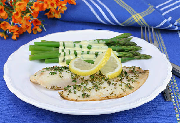istock Tilapia filets with a side of asparagus hollandaise. 487599548