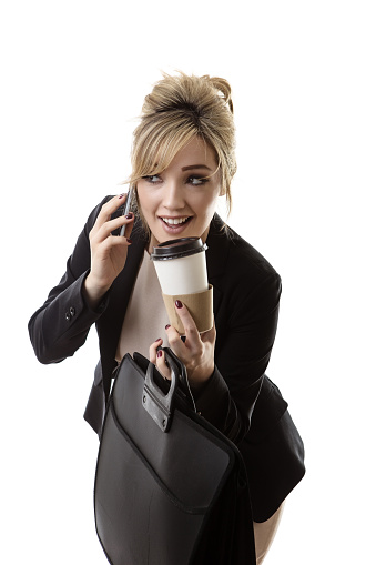 business woman on the phone spilling her drink on her way to work
