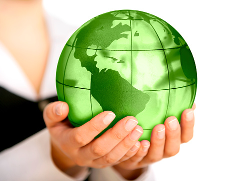Earth globe (America view) in businesswoman's hands. Selective focus, white background.