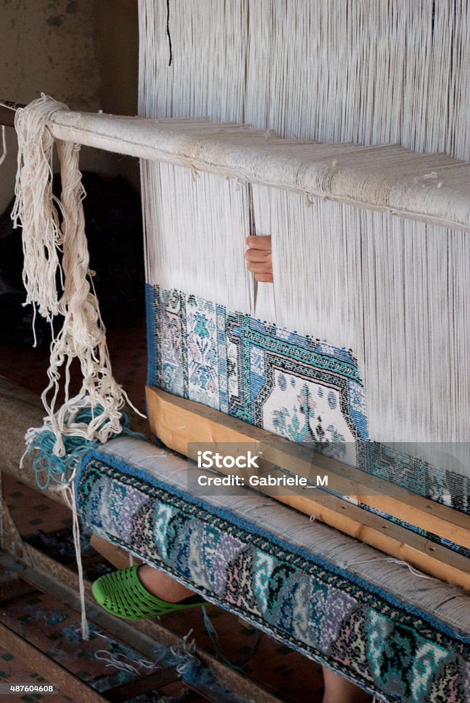Traditional Maroccan Loom Loom worker in Marrakesh, 2013. A woman is weaving a carpet following the traditional technique. Copyright-free. Backstrap Loom Stock Photo