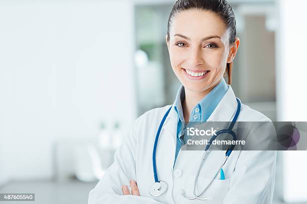 Confident Female Doctor Posing In Her Office Stock Photo - Download Image Now - Female Doctor, Confidence, Stethoscope