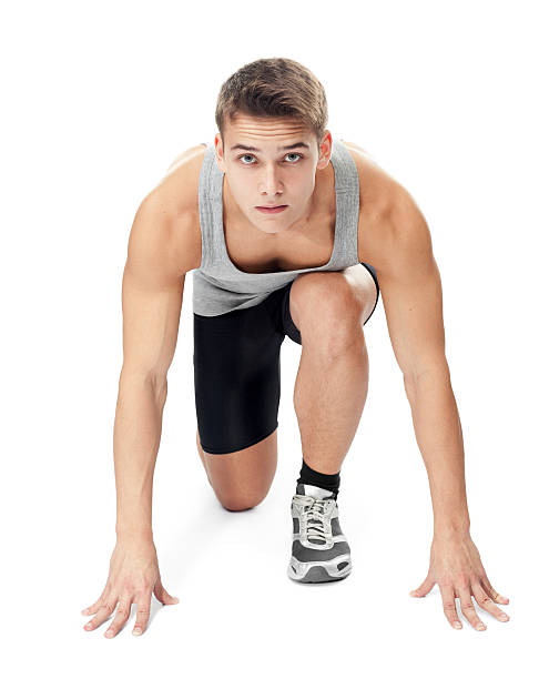 Full length portrait of a male athlete ready to run Full length portrait of athlete man ready to run, looking at camera isolated on white background gray eyes photos stock pictures, royalty-free photos & images