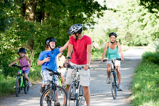 istock Family cycling in park. 487607289