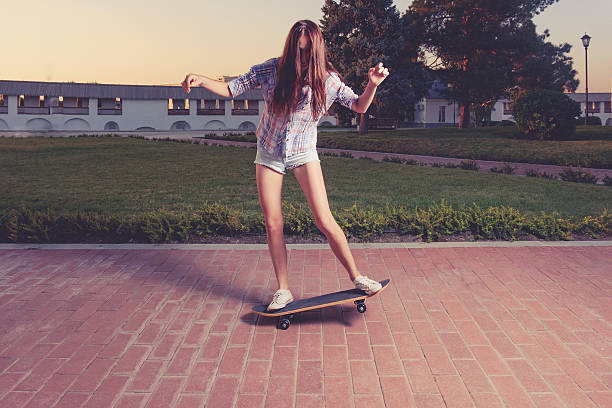 istock Women riding skateboard toned image 487608158