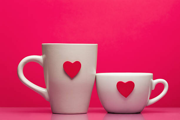 istock Cups with valentines day heart on pink background 487608315