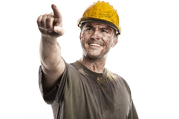 istock pointing young dirty Worker Man With Hard Hat helmet 487608595