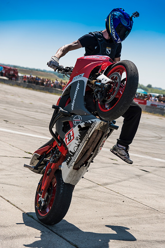 Vinnytsia,Ukraine-July 25, 2015: Unknown stunt biker entertain the audience before the start of the championship of drifting   on July 25,2015 in Vinnytsia, Ukraine.