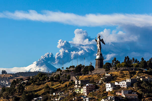 Cotopaxi volcano eruption Cotopaxi volcano eruption and Panecillo's Madona seen from Quito, Ecuador quito photos stock pictures, royalty-free photos & images