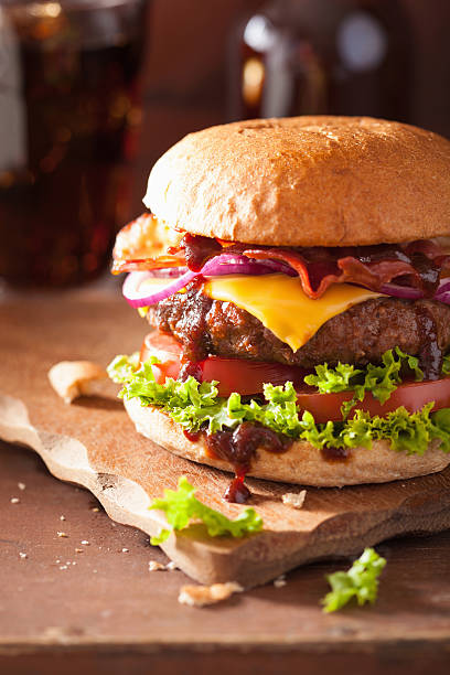 istock bacon cheese burger with beef patty tomato onion cola 487614620