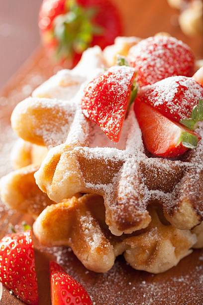 istock belgian waffles with icing sugar and strawberry 487614638