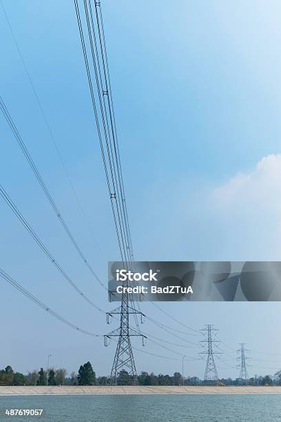 Power Transmission Line On High Voltage Post Beside The Sea Stock Photo - Download Image Now