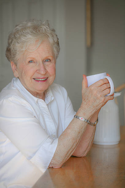 istock Beautiful senior woman enjoying her tea or coffee 487619766