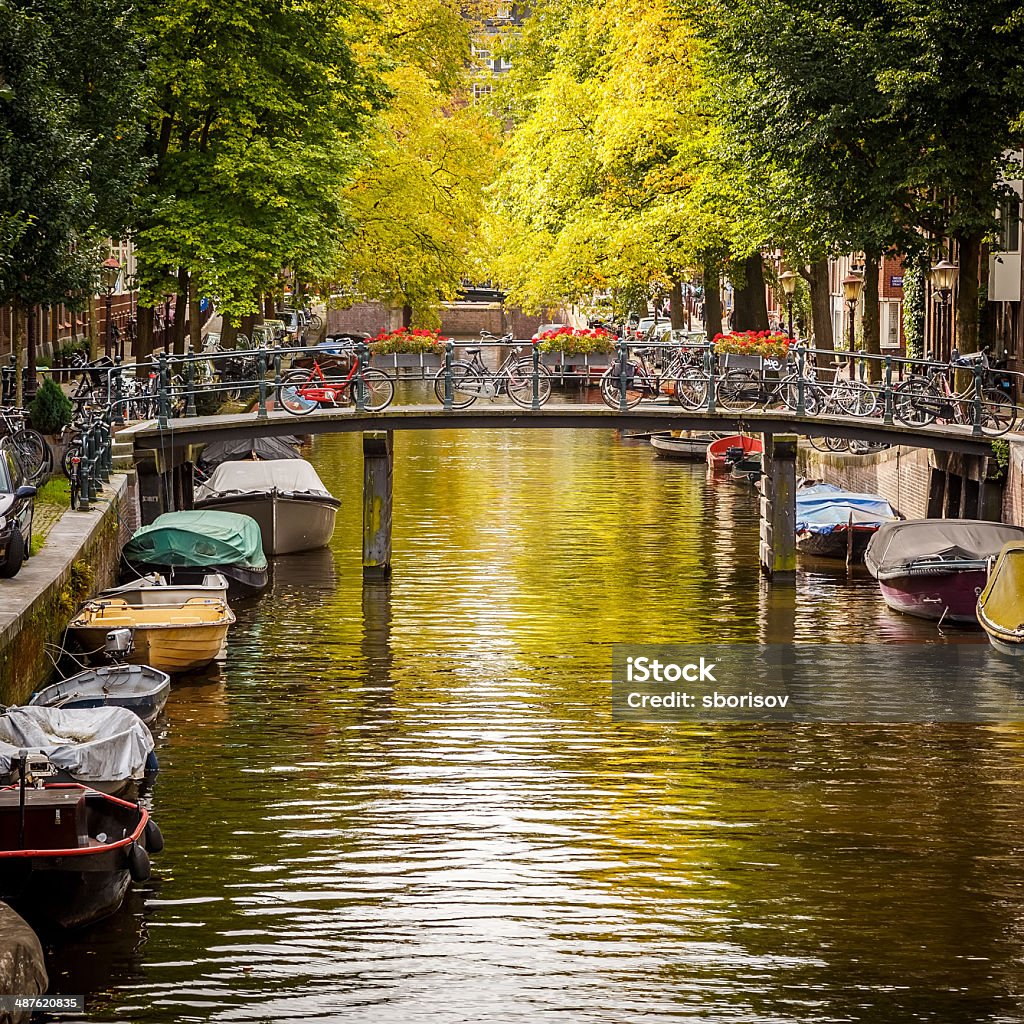 Canal in Amsterdam Bridge over canal in Amsterdam Amsterdam Stock Photo