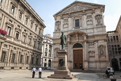 The octagonal Baptistery of Saint John in Florence, completed in the 12th century, together with the Cathedral and the Giotto's Campanile, is part of the UNESCO World Heritage Site. Tourists strolling in the square.