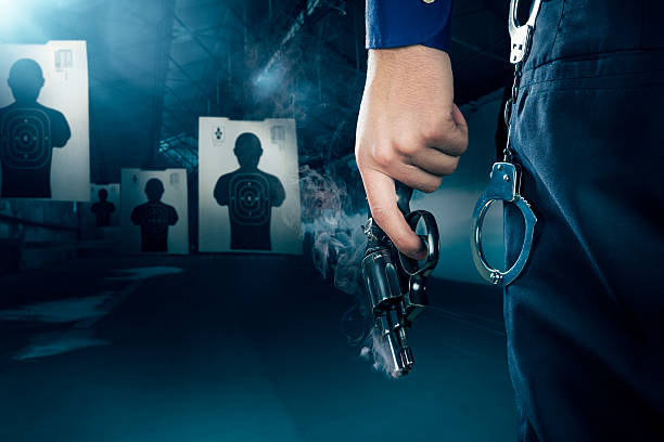 istock Police officer holding a gun at shooting range 487627214